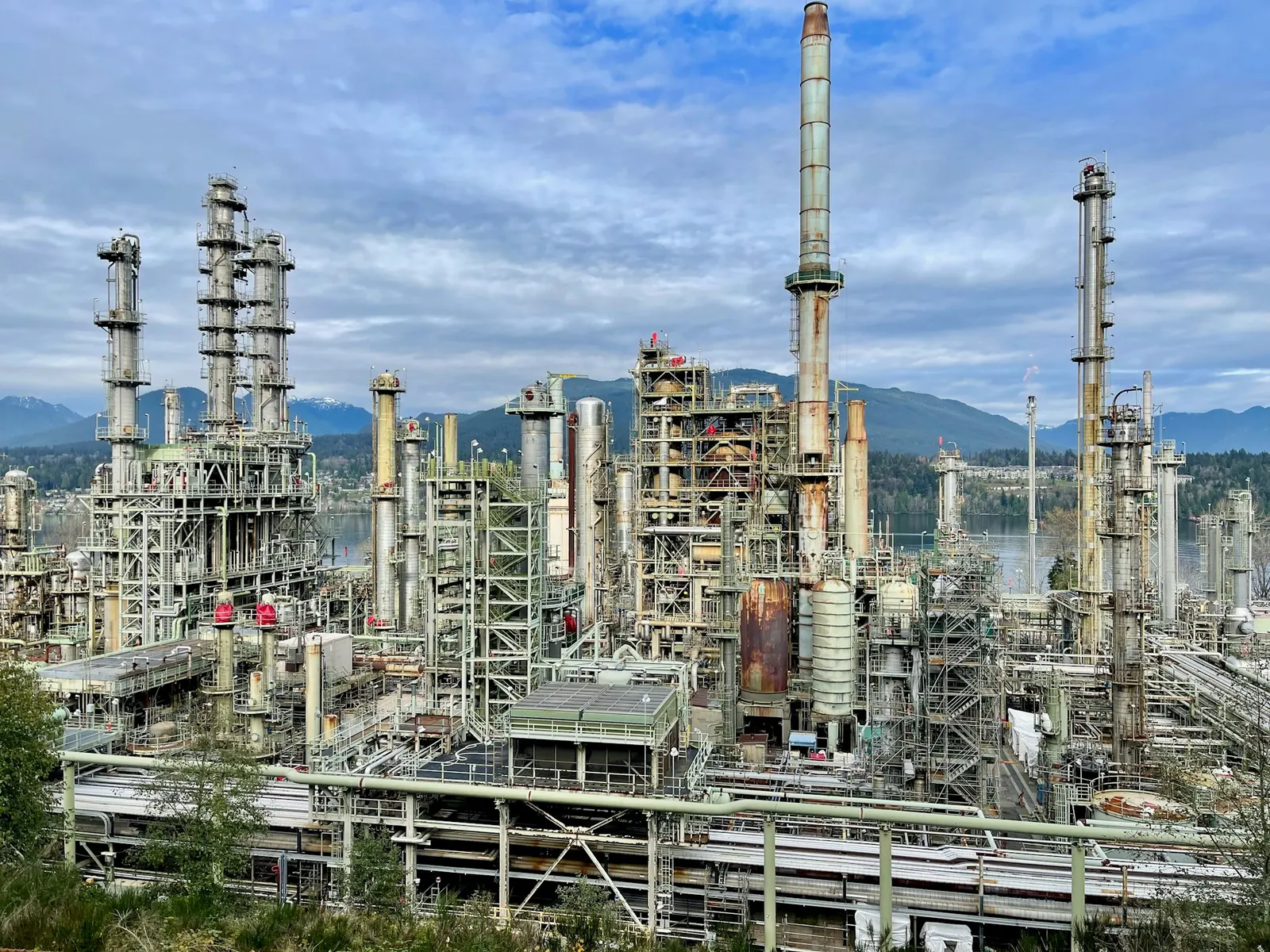 Refinery towers and pipework under a cloudy sky